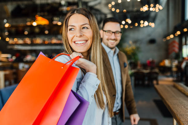 Smiling tourist holding Visa Classic card

