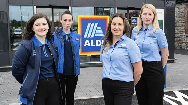 Store staff restocking shelves at Aldi